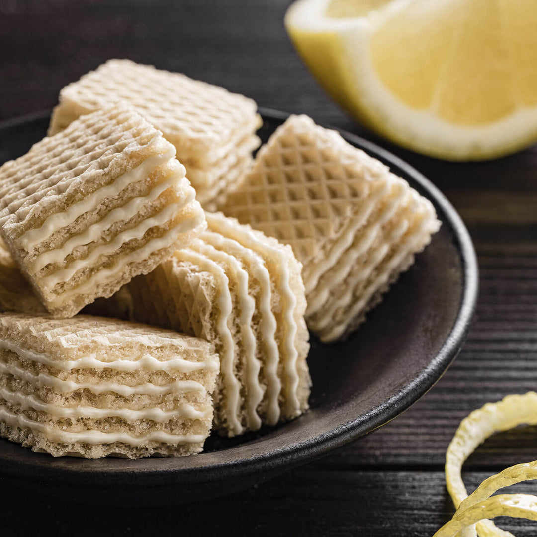 Quadratini Lemon, Crème-Filled Wafer Cookies, 8.82 oz. Bag closed up with a lemon next to it.