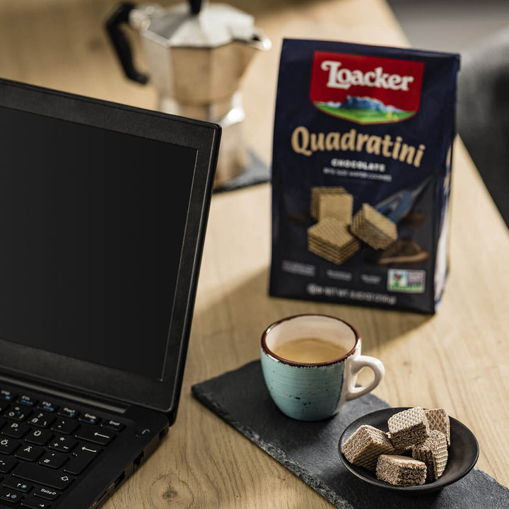 Quadratini Chocolate, Creme-Filled Wafer Cookies, 8.82 oz. Bag with laptop and coffee next to it