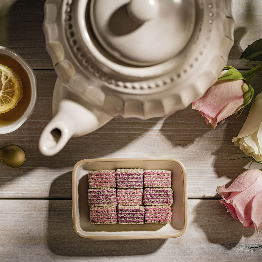 Quadratini Raspberry-Yogurt, Creme-Filled Wafers, 7.76 oz. Bag with unwrapped wafers and teapot next to it